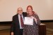 Dr. Nagib Callaos, General Chair, giving Dr. Nanda van der Stap the best paper award certificate of the session "Learning and Education (Concepts, Technologies and Methodologies)." The title of the awarded paper is "Facilitating Effective Student Participation in an Online Environment."